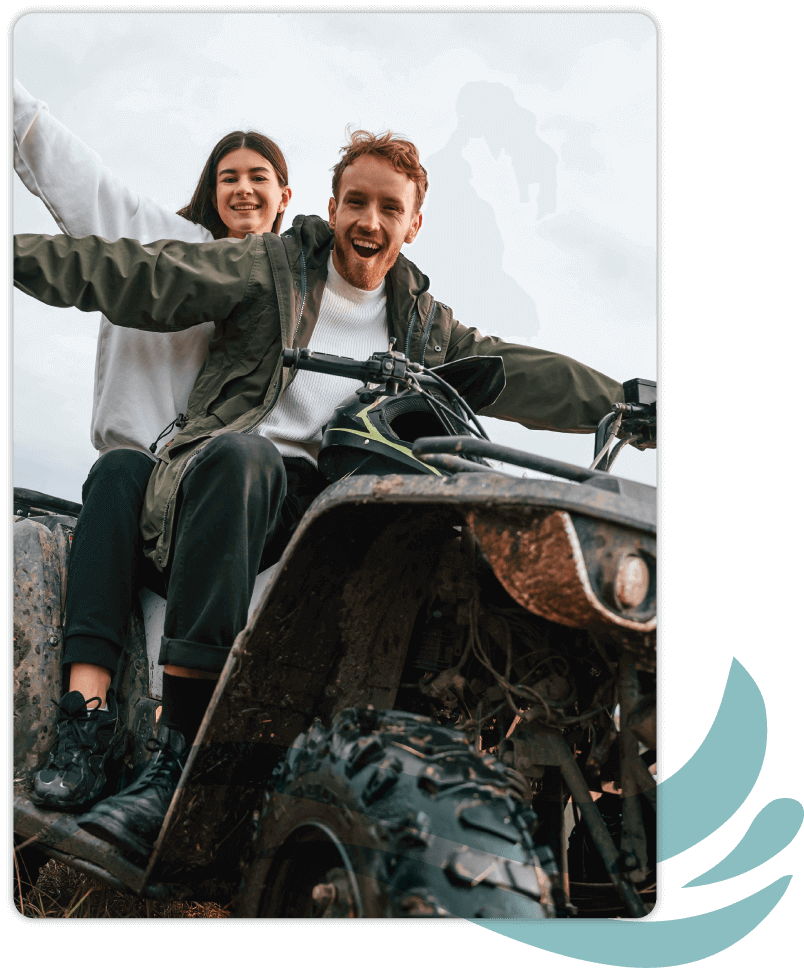Young couple having fun riding an atv